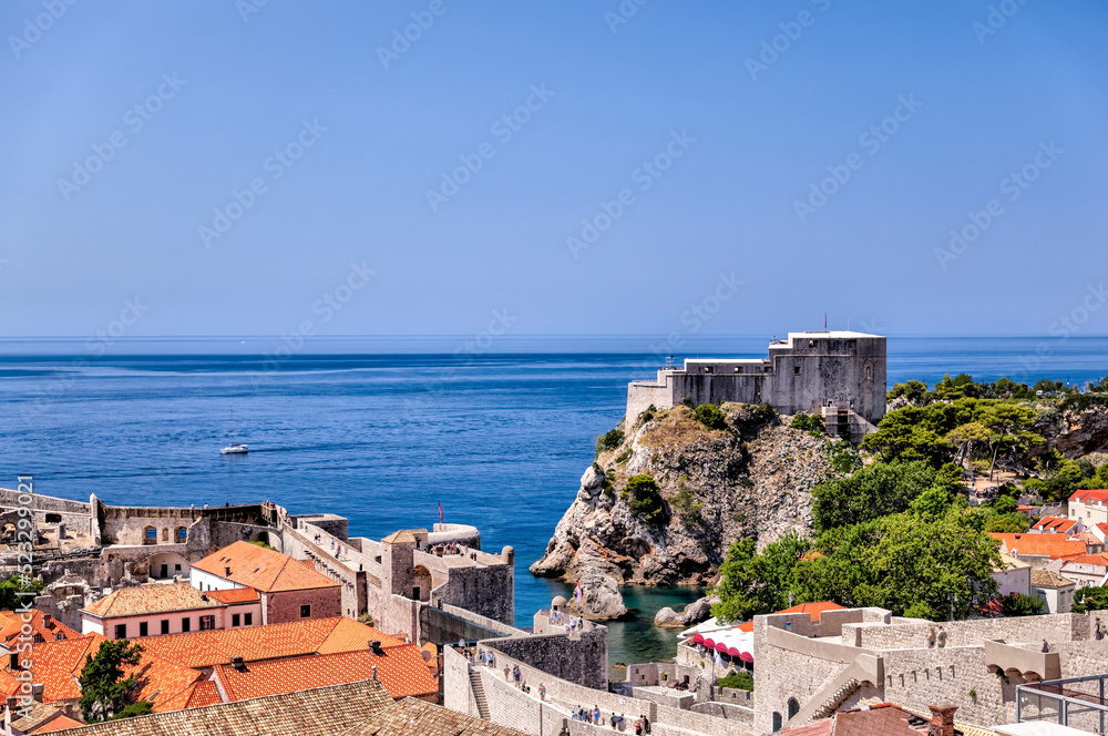 Medieval architecture in the walled city and the rugged coastline of Dubrovnik, Croatia with views of the Adriatic Sea