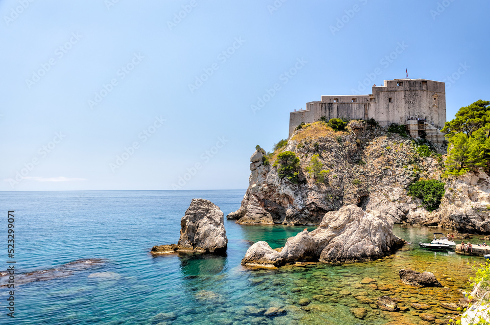 Medieval architecture in the walled city and the rugged coastline of Dubrovnik, Croatia with views of the Adriatic Sea Medieval architecture in the walled city and the rugged coastline of Dubrovnik, Croatia with views of the Adriatic Sea