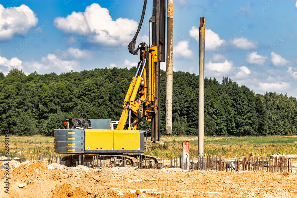Powerful hydraulic drilling rig at a construction site. The device of pile foundations. Bored piles. Heavy construction equipment. Powerful hydraulic drilling rig at a construction site. The device of pile foundations. Bored piles. Heavy construction equipment.
