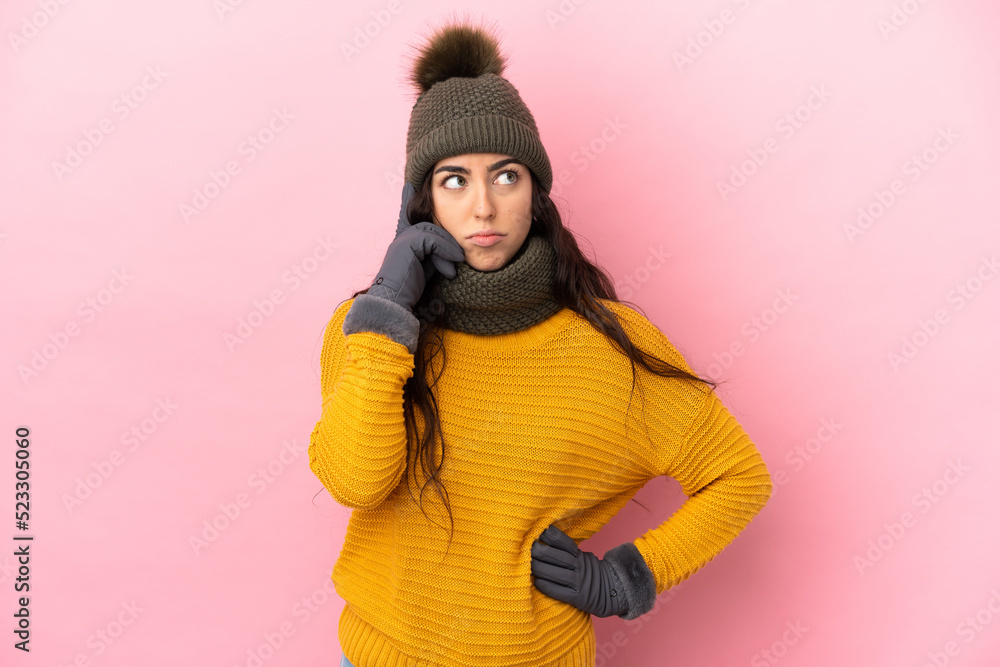 Young caucasian girl with winter hat isolated on purple background thinking an idea Young caucasian girl with winter hat isolated on purple background thinking an idea