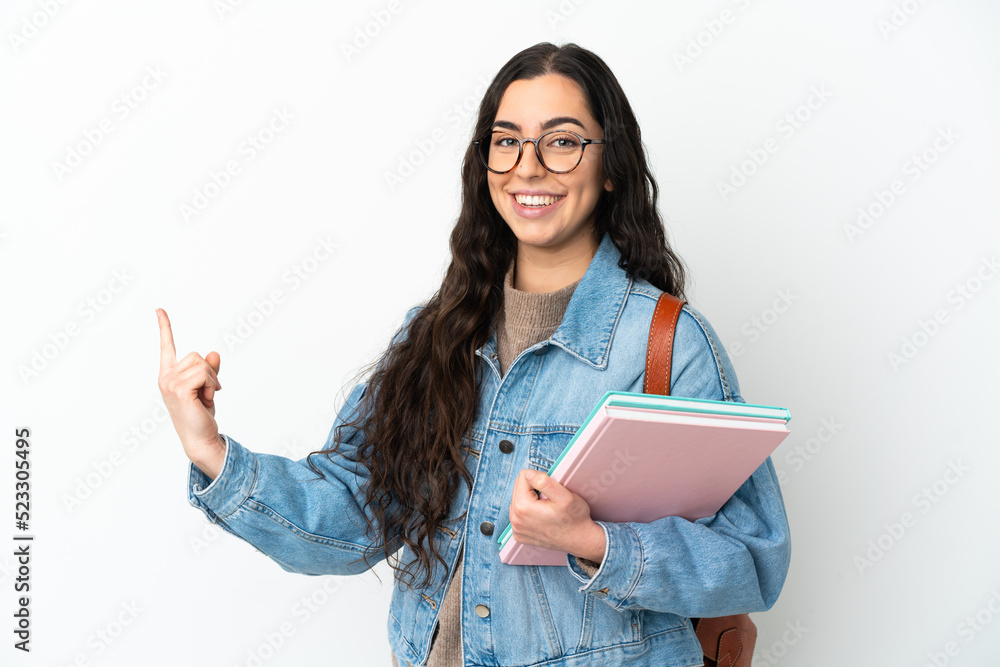 Young student woman isolated on white background pointing back Young student woman isolated on white background pointing back