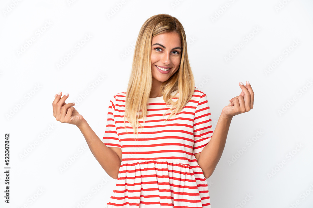 Blonde Uruguayan girl isolated on white background making money gesture Blonde Uruguayan girl isolated on white background making money gesture