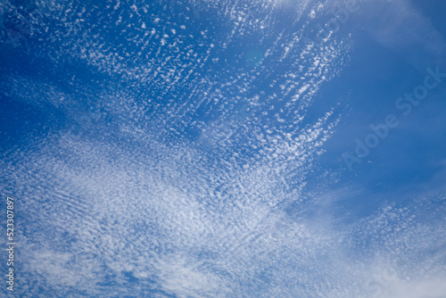 Bright and intense blue sky with white altocumulus clouds perfect for backgrounds and graphic resources photo