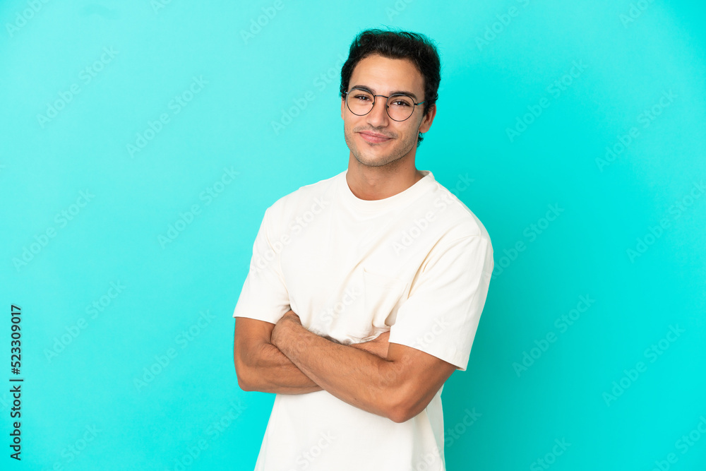 Caucasian handsome man over isolated blue background with arms crossed and looking forward Caucasian handsome man over isolated blue background with arms crossed and looking forward