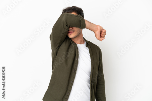 Caucasian handsome man over isolated white background covering eyes by hands