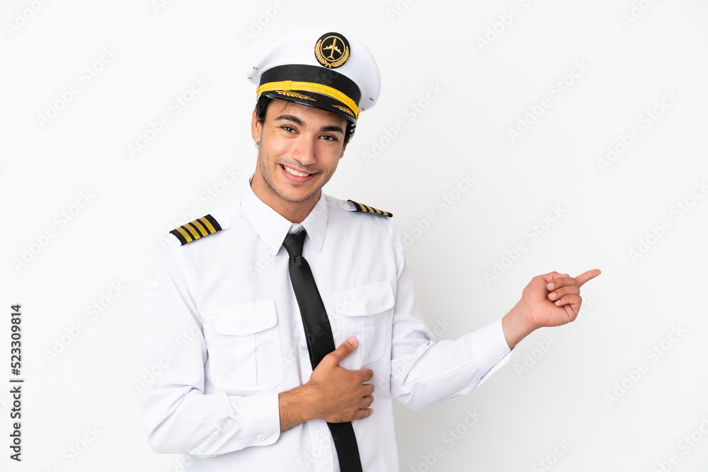 Airplane pilot over isolated white background pointing finger to the side