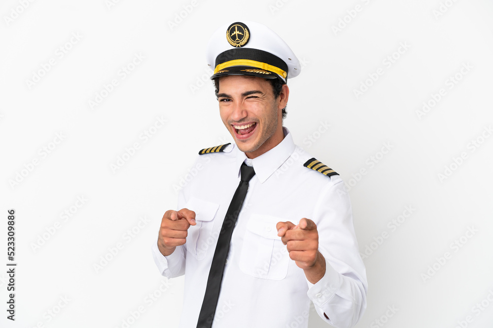 Airplane pilot over isolated white background pointing to the front and smiling Airplane pilot over isolated white background pointing to the front and smiling
