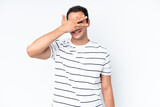 Young caucasian man isolated on white background covering eyes by hands and smiling