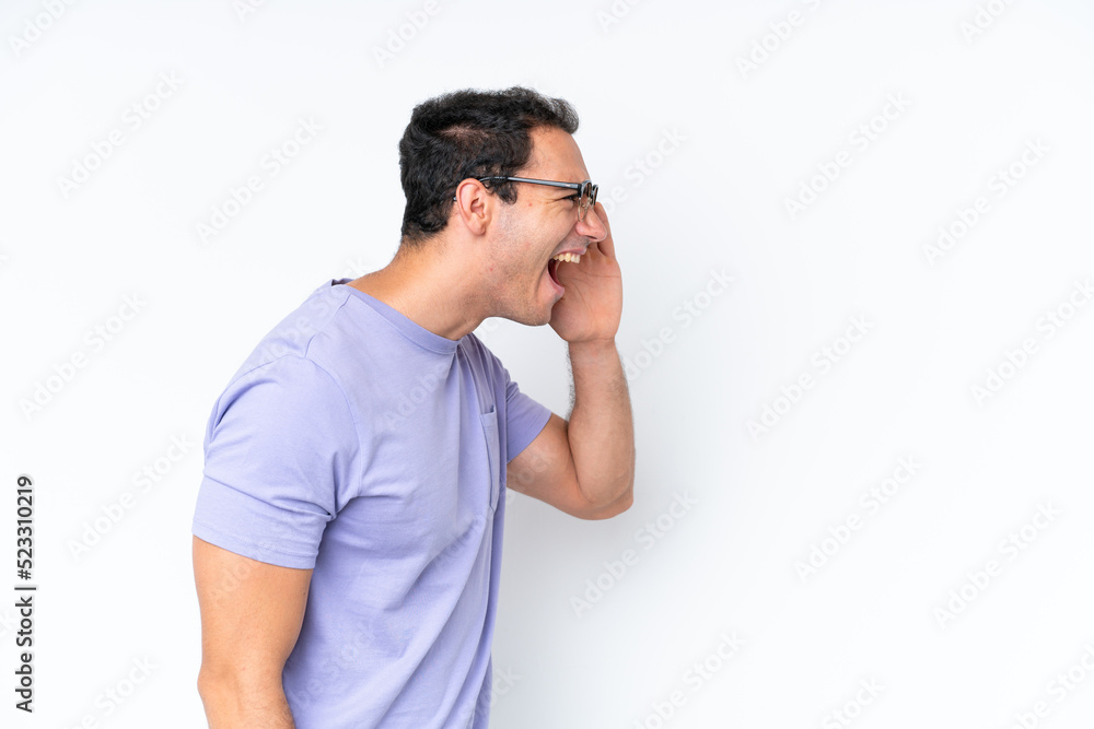 Young caucasian man isolated on white background shouting with mouth wide open to the side Young caucasian man isolated on white background shouting with mouth wide open to the side
