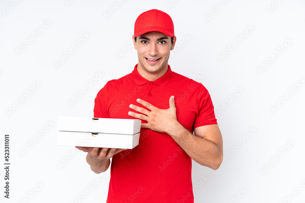 Pizza delivery caucasian man with work uniform picking up pizza boxes isolated on white background surprised and shocked while looking right Pizza delivery caucasian man with work uniform picking up pizza boxes isolated on white background surprised and shocked while looking right