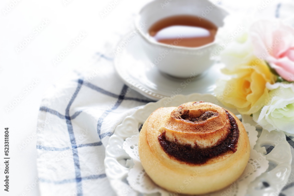 Cinnamon bun on white dish for breakfast image