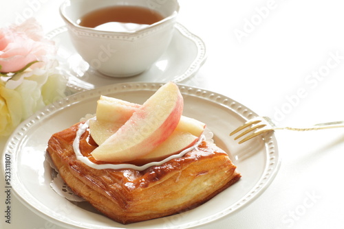 Homemade peaches Danish pastry on dish with copy space