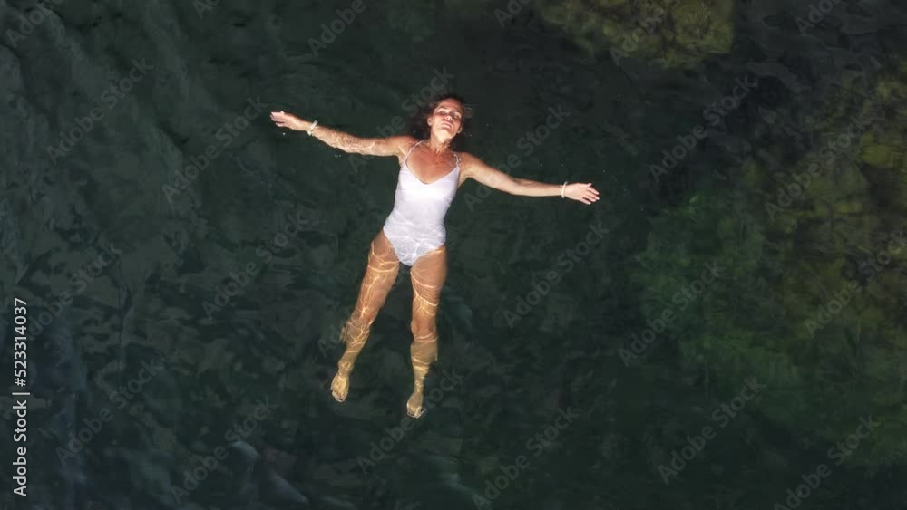 custom made wallpaper toronto digitalWoman floating sea. Aerial top view of young pretty woman in white swimsuit floating on water surface in crystal clear turquoise sea. Vacation at Paradise. Ocean relax, travel and vacation.