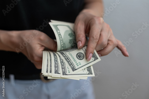 young girl isolated over white wall background holding money.