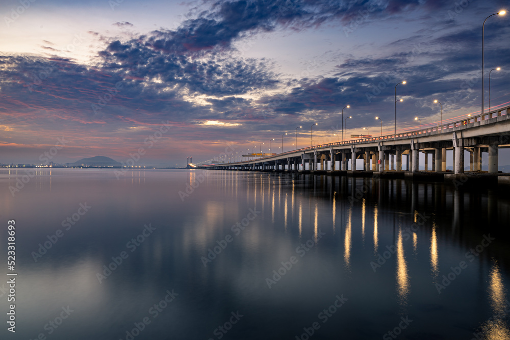 Obraz premium Sunrise shoot under the Penang Bridge. Penang bridges are crossings over the Penang Strait in Malaysia. They connect the area of Seberang Perai on the Malay peninsula with the island of Penang.