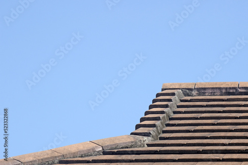 Abstract of a section of roof on a resedential house with clear blue sky background for copy space