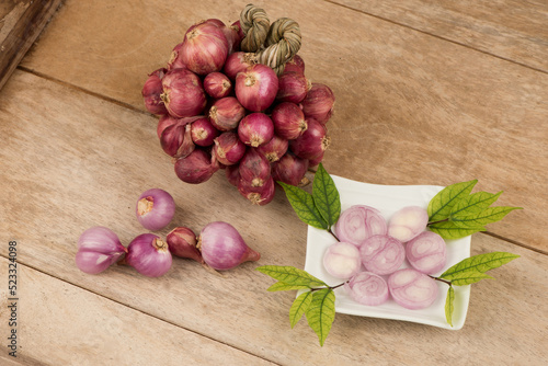 Red shallots on an old wood background.