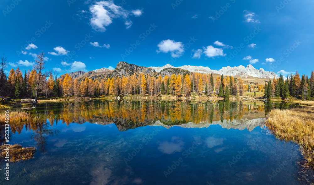 Fototapeta premium Autumn alpine mountain lake near San Pellegrino Pass, Trentino, Dolomites Alps, Italy.