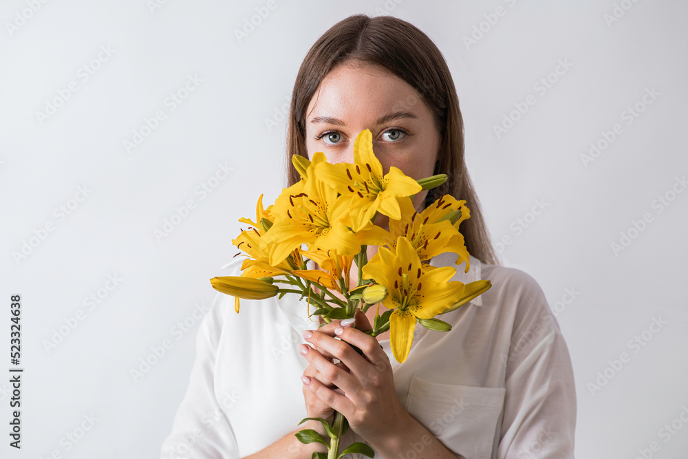 Beautiful young woman with fresh lilies on white background Beautiful young woman with fresh lilies on white background