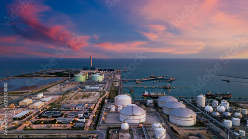 Aerial view oil terminal and coal power plant station in sea, White oil storage tank chemical petroleum petrochemical refinery product, Tanker ship at deep ocean seaport terminal. photo
