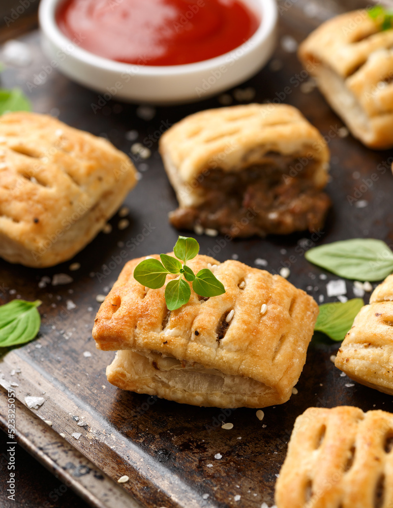 Mini beef patties with vegetables and red wine wrapped in puff pastry