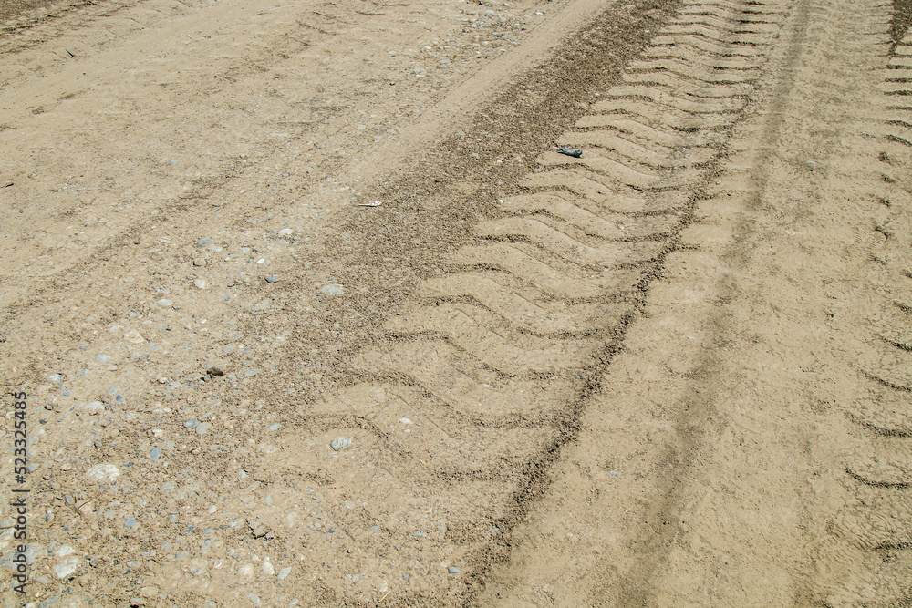 Naklejka premium Tractor tracks on dry ground