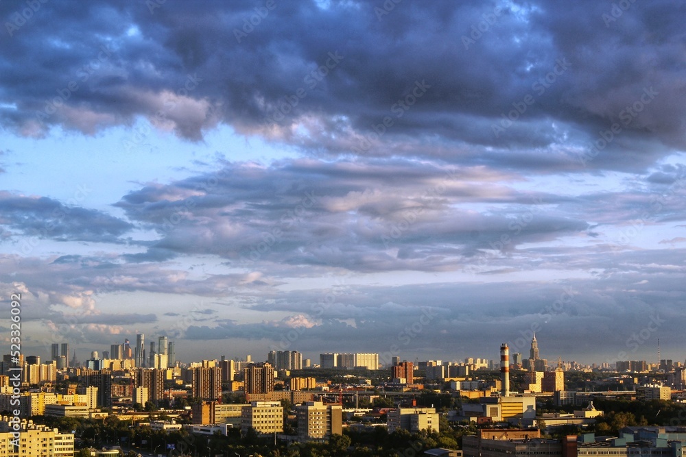 Fototapeta premium Aerial panoramic district view of sunrise in Moscow. City street urban residential buildings, wonderful beautiful dramatic clouds sky. Modern houses of Russia region