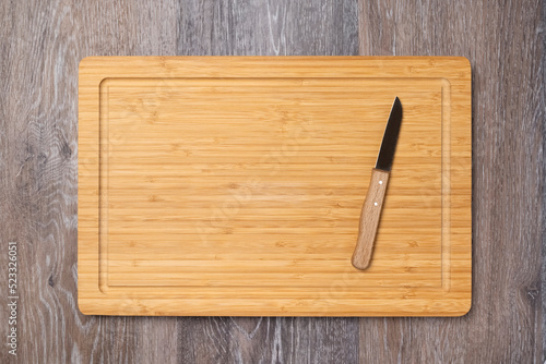 Knife on an empty kitchen board, kitchen background