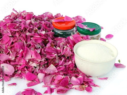 grinding fragrant petals of rosa centifolia with sugar for rose jam as preserve photo