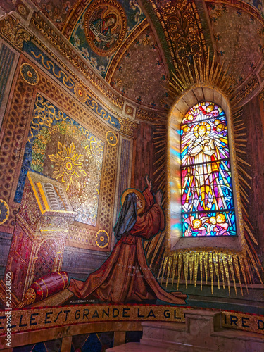 Stained glass window of Saint margueritte marie alacoque and the sacred heart of jesus, in the chapel of Saint claude de la colombière, paray-le-monial, center of france.  photo