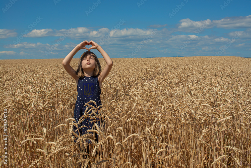 Ukrainian girl is in the field of wheat. The child prays for peace in Ukraine. Ukrainian girl is in the field of wheat. The child prays for peace in Ukraine.