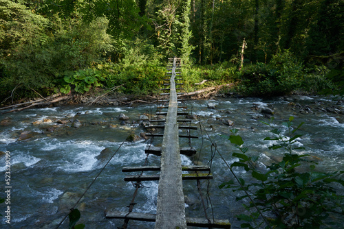 suspension bridge over a stormy mountain river and jungle on a hike