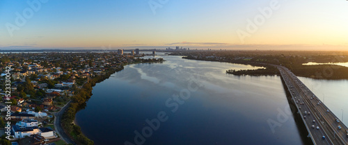 Dawn breaks over Perth's Canning River with the city skyline on the horizon