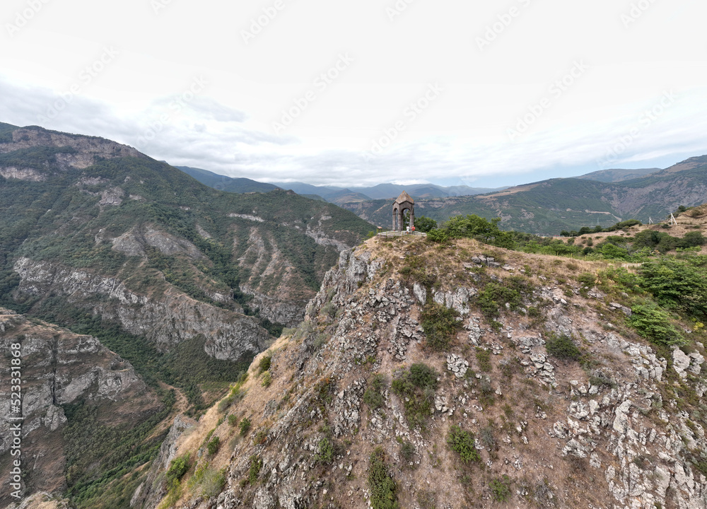 panoramic views of ancient temples and buildings in picturesque places in a gorge in the mountains of Armenia taken from a drone