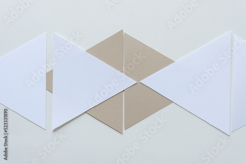 geometric shapes arranged on paper - beige and white triangles