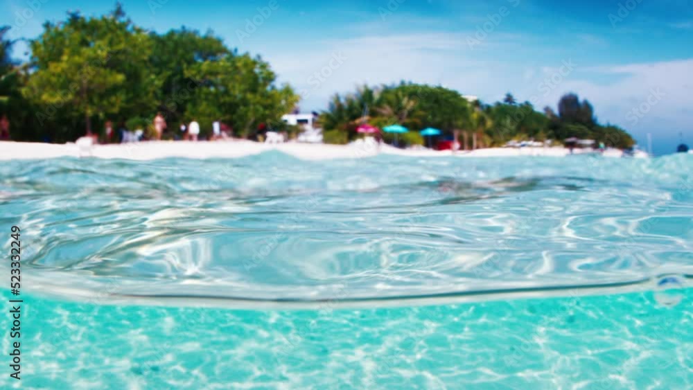 Tropical blue sea with island. Splitted view of the tropical island and the sea in the Maldives Tropical blue sea with island. Splitted view of the tropical island and the sea in the Maldives
