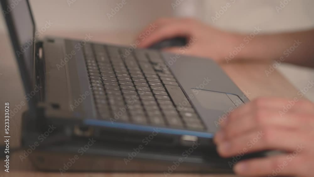 a person presses different keys while working at a laptop a person presses different keys while working at a laptop