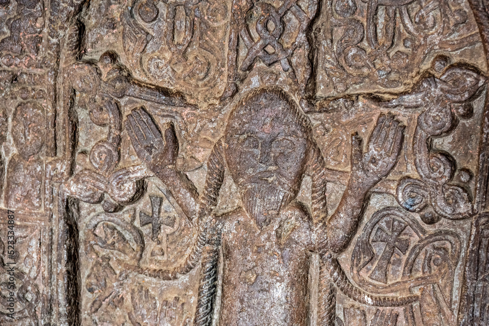 ancient Armenian bas-reliefs in temples on a religious theme, made with portraits of saints with features of the Mongoloid race