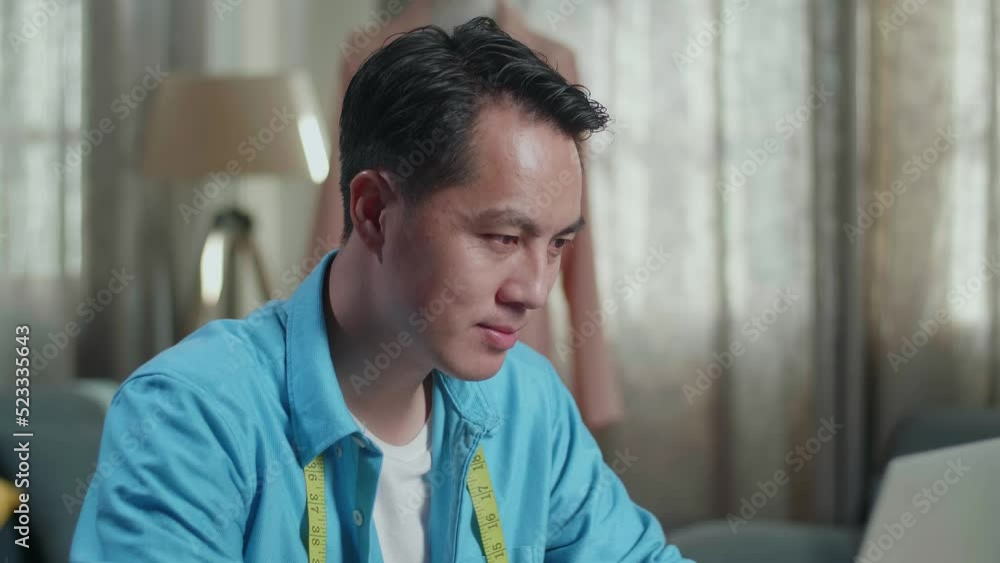 Close Up Of Asian Male Designer Working On A Laptop And Smiling And Thumb Up To The Camera While Designing Clothes In The Studio
Close Up Of Asian Male Designer Working On A Laptop And Smiling And Thumb Up To The Camera While Designing Clothes In The Studio