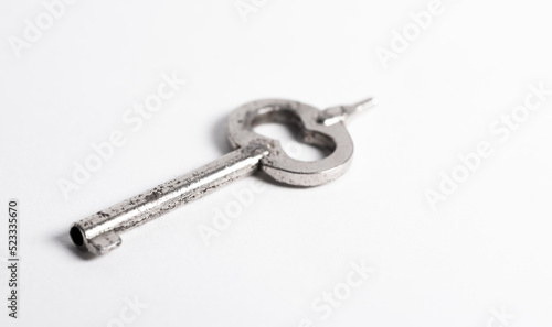 A police handcuff key isolated on a white background. Key to freedom concept. © PhotoRK