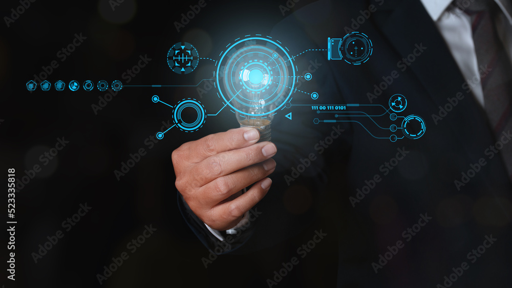 Fototapeta premium Businessman holding glowing light bulb with digital transformation change management, internet of things.