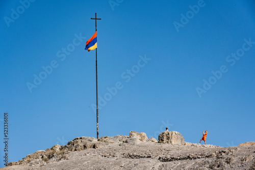 Armenian flag in iconic places on a peak in the mountains of Armenia