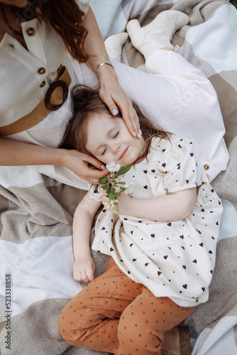 Daughter lies on her mother's lap © Kaplitskaya Love