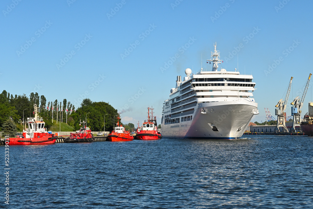 View of the port of Gdansk, tugboats and cruise ship.