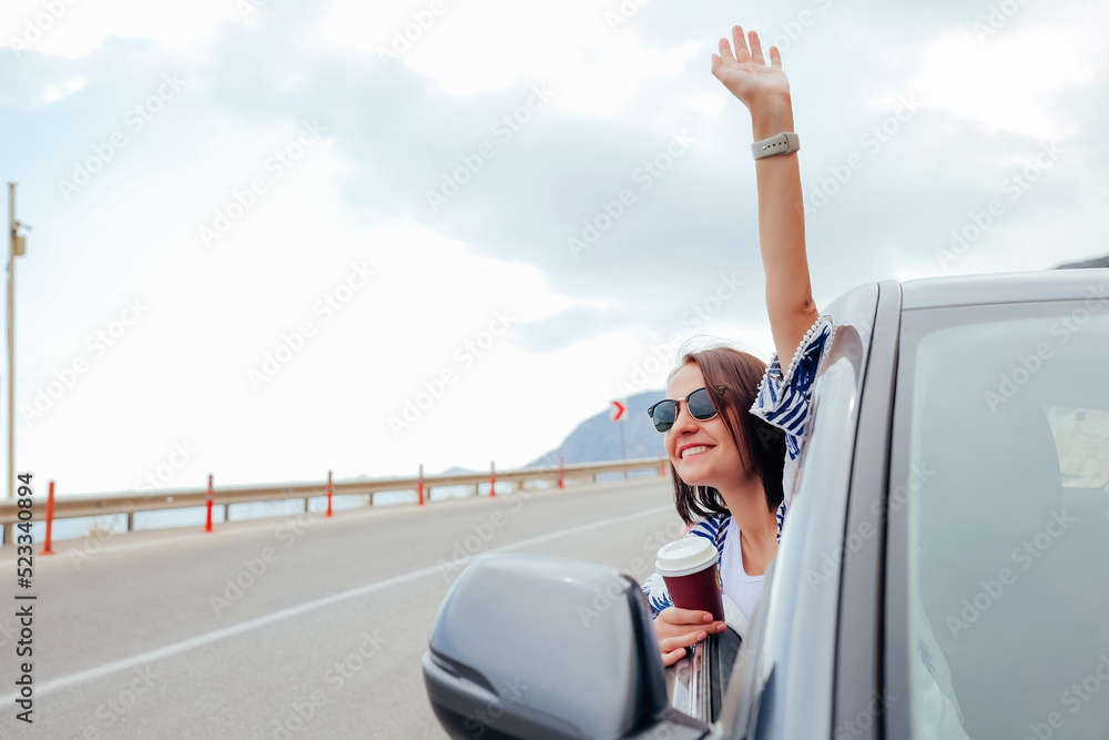 Happy smiling young woman passenger drinking takeaway coffee Happy smiling young woman passenger drinking takeaway coffee