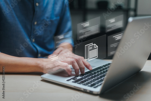 Businessman working on laptop with virtual screen. Process automation to efficiently manage files. Online documentation database and document management system concept.