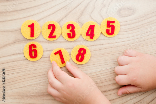 Felt apple tree with numbers. Preschool implement to help for children to learn counting. Montessori concept, early education. Kids hand on toy.