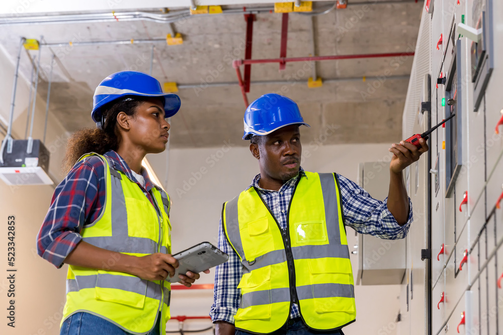 Electrical engineer working in control room. Electrical engineer man