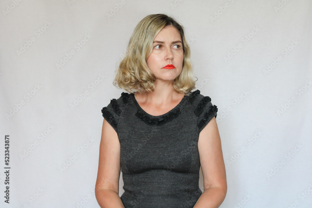 Fototapeta premium Beautiful middle-aged blond woman on a white background