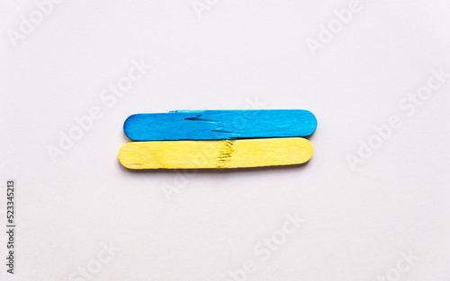 broken flag of ukraine. National flag of Ukraine on wooden sticks. War in Ukraine. political conflict.